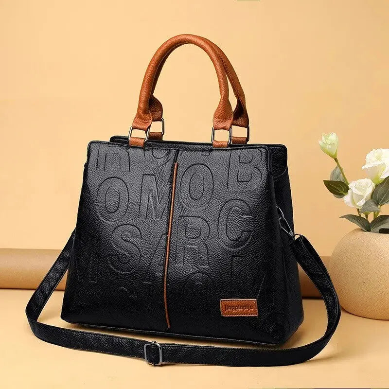 Drune – Damenhandtasche aus weichem Leder mit geprägtem Buchstabendesign