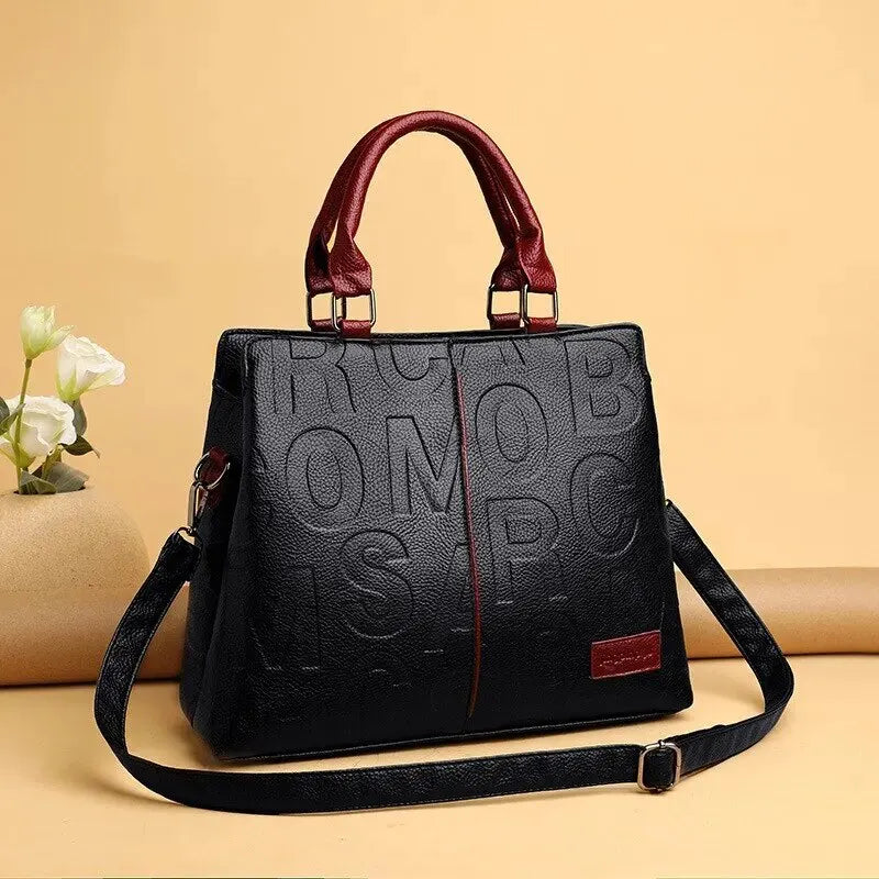 Drune – Damenhandtasche aus weichem Leder mit geprägtem Buchstabendesign